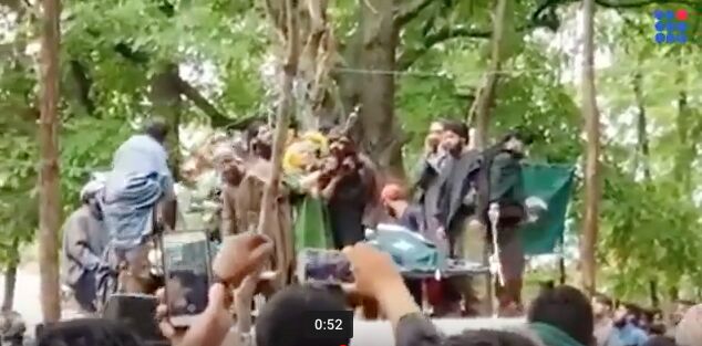 AK 47 salute by mother of slain HM militant