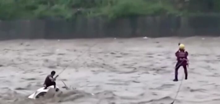 Typhoon Doksuri : Miraculous Rescue Caught on Video man Trapped in Swollen River Saved from Certain Disaster