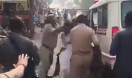 A video grab of a woman protester being pushed into the police jeep.